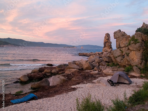 purple sunset beaches. tent on the each against purple sunset