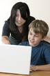 adult woman and child at computer