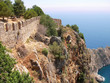 castle wall on the rock above mediterranean sea at alanya