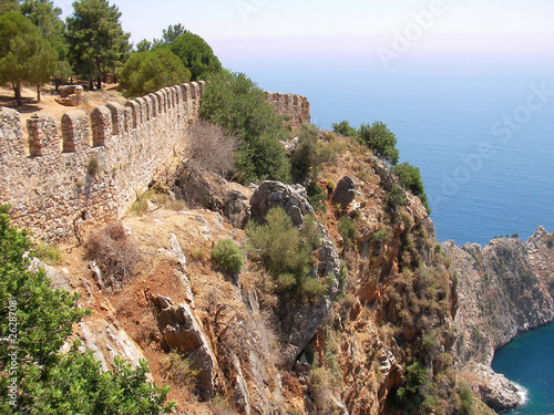 castle wall on the rock above mediterranean sea at alanya