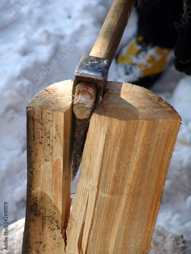an axe splitting wood