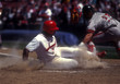 baseball runner sliding into home plate