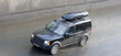 suv land rover discovery drives through rain suv land rover discovery drives through rain