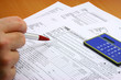 Photo: hand and tax forms hand and tax forms