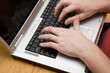 hands typing on laptop computer hands typing on laptop computer