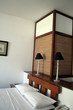 modern bedroom double bed with white sheets and pi