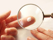 Photo: cream is being tested under magnifier cream is being tested under magnifier