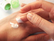 female hands applaing a cream close up.