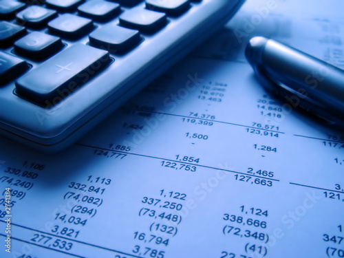 Photo: financial statement with calculator and pen financial statement with calculator and pen