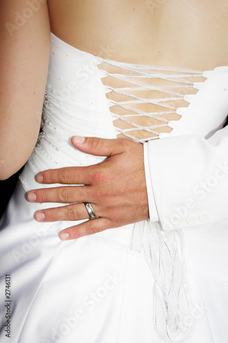 Photo: bridegrooms hand on the back of his bride bridegrooms hand on the back of his bride