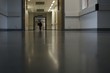 man walking along hospital corridor