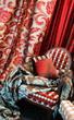 luxurious red chair with satin pillows and curtains