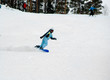a girl riding fast on the snowboard 2