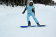 smiling girl showing she's tongue on the snowboard