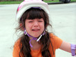 child wearing a bike helmet crying