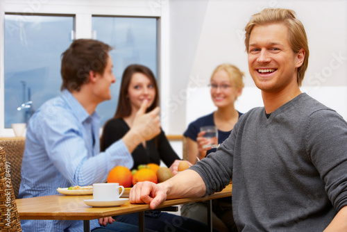 portrait of a young man in front of a workgroup
