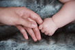 baby hand holding daddy's hand