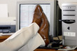 feet propped up on a desk