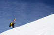 the climber rises on a crest of mountain