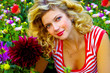 beautiful girl among dahlia flowers