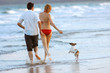 couple and dog on beach couple and dog on beach