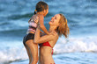 mother and daughter playing in the ocean
