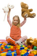 girl in the middle of toy-mess