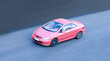 woman driving small pink coupe car fast speed woman driving small pink coupe car fast speed