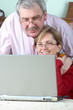 mature couple using laptop