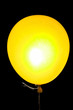 yellow balloon on a string backlight isolated