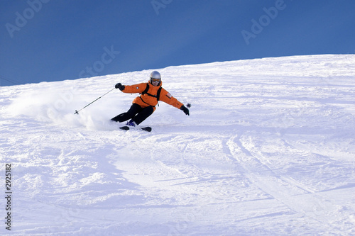 ski rider in orange sharp turn