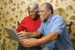 mature couple looking at laptop.
