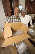 Photo: middle-aged couple unpacking boxes. middle-aged couple unpacking boxes.