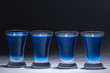 Photo: blue vodka in four glasses blue vodka in four glasses