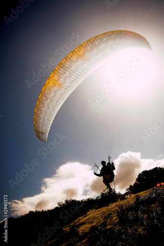 Photo: paraglider launching from the mountain ridge paraglider launching from the mountain ridge