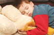 the child sleeping in clothes on a soft toy