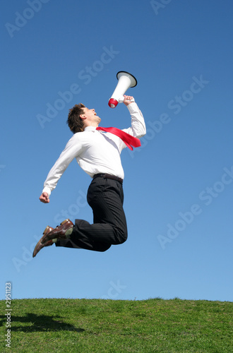 businessman jumping with megaphone