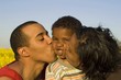 parents kissing their cute little son