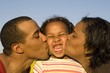 parents kissing their cute daughter parents kissing their cute daughter