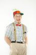 young man dressed like nerd with hands in pockets.