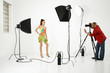 Photo: young female model being photographed by male photographer. young female model being photographed by male photographer.