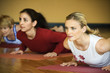 adult females in yoga class.