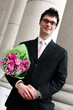 happy man with flowers under his arm