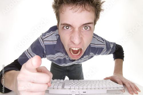 Photo: teenage boy angry at computer teenage boy angry at computer