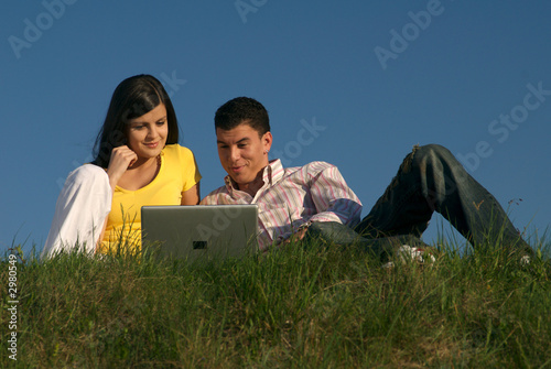 couple with laptop in nature