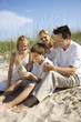 Family sitting on beach.