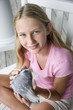 Girl holding conch shell.