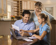 Photo: Family paying bills on computer. Family paying bills on computer.