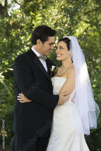 Photo: Bride and groom embracing. Bride and groom embracing.