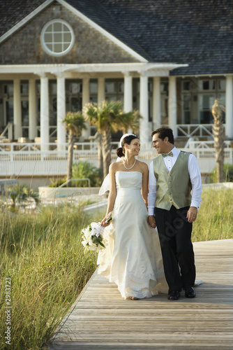 Bride and groom walking.